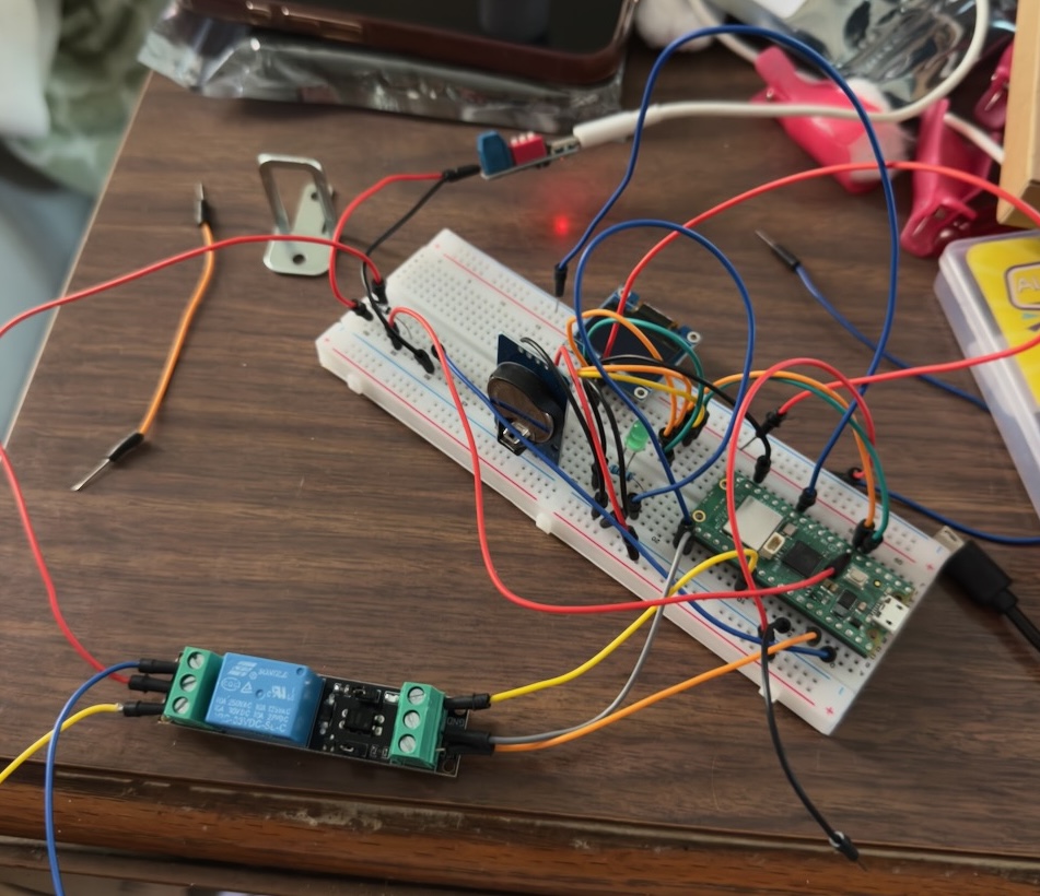 Breadboard prototype with relay, Pico, and lock wired up